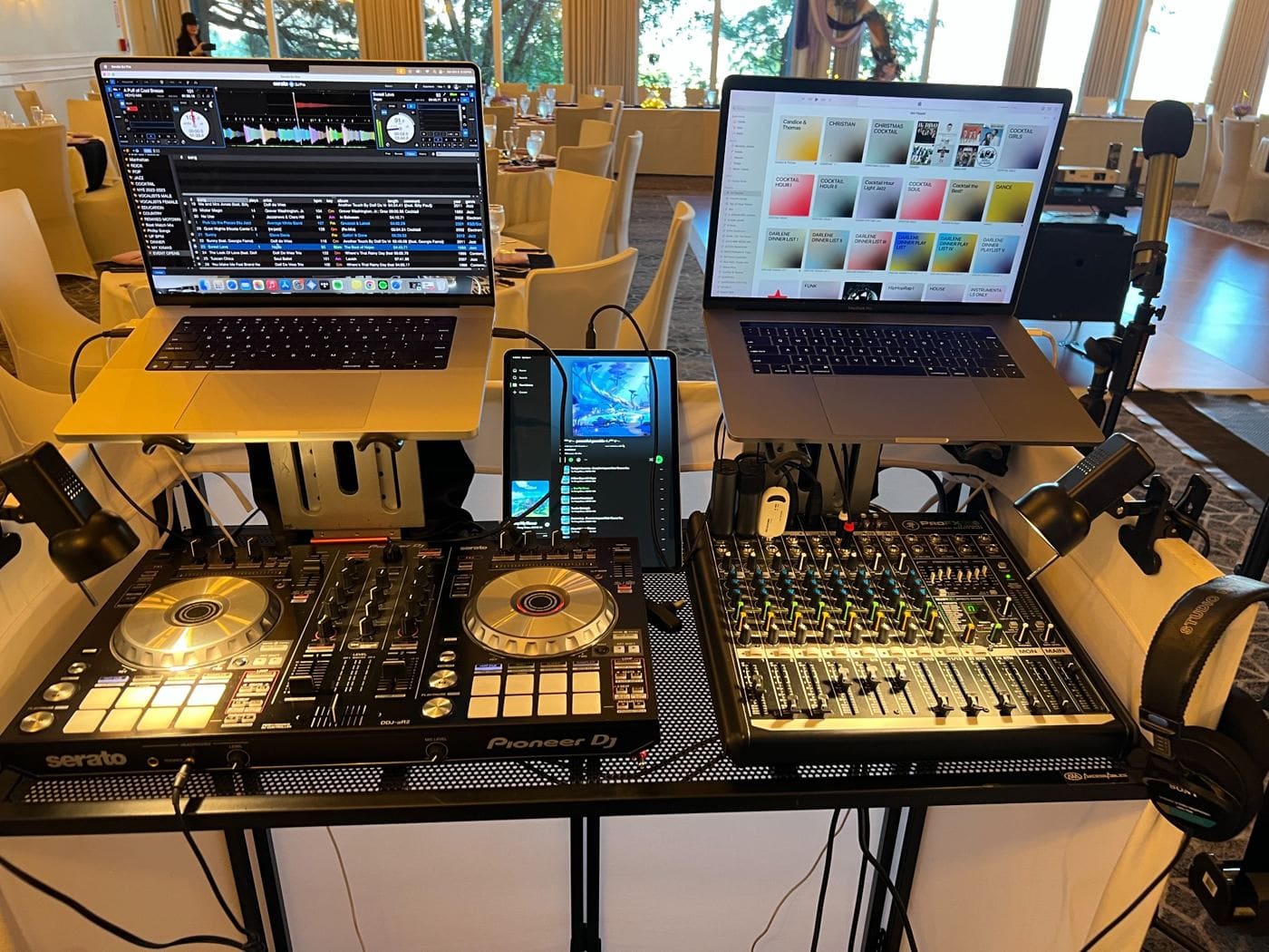Two DJ setups with Pioneer equipment, laptops showing music software, and mixing consoles in an elegant venue